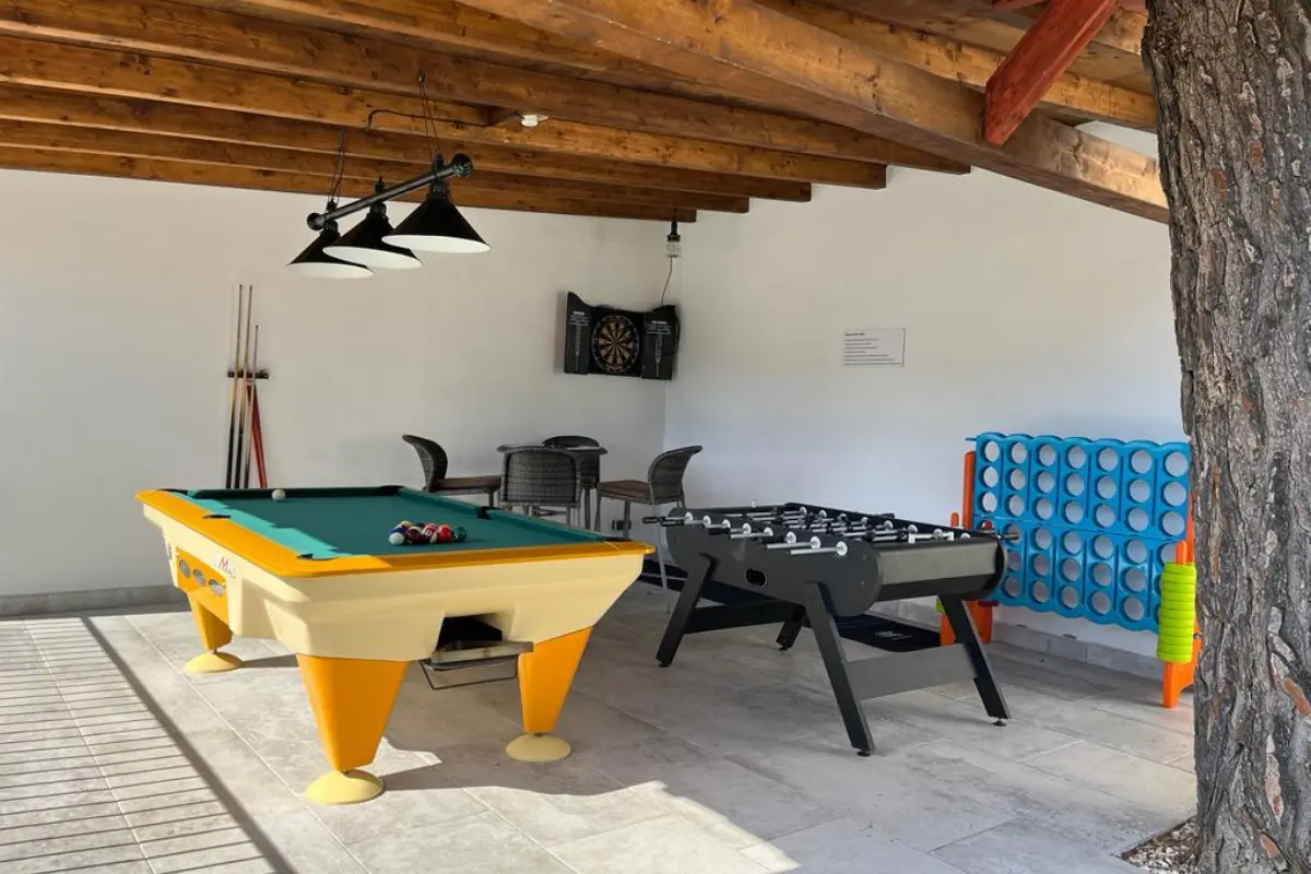 Outdoor games area at El Molinete with a pool table and table football